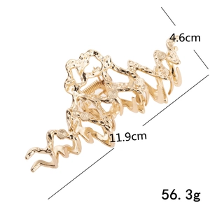 Golden liquid metal hair claw clip with irregular wavy texture and size dimensions