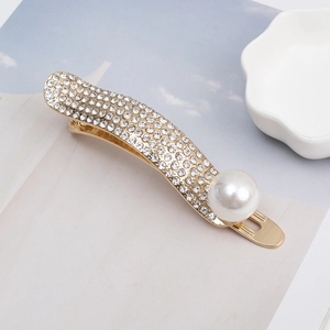 Eleganter goldener Haarclip mit funkelnden weißen Strasssteinen und Akzentperle