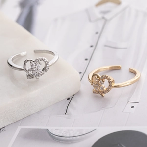 Fashionable hollow heart open ring with micro-set zircons in gold and silver finish