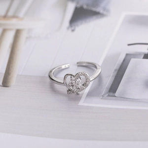 Adjustable silver heart ring featuring hollow design and micro-pave cubic zirconia stones