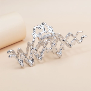 Silver liquid metal shark hair claw clip with irregular molten texture for women