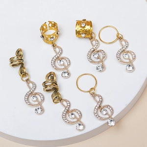 Accessoires de dreadlocks dorés avec pendentifs notes de musique et strass sur socle