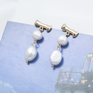 Elegant gold drop earrings featuring baroque pearls and irregular metal bars for women