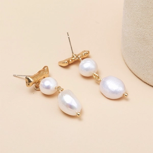 Elegant gold textured metal earrings with mismatched pearls in a vintage drop style