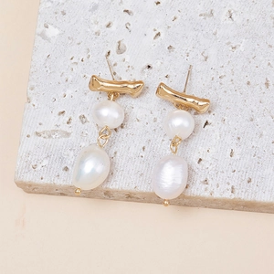 Elegant gold bamboo joint earrings featuring natural white drop-shaped pearls on a stone base