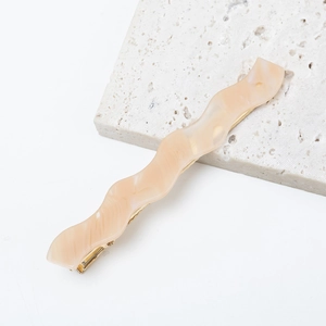 French wavy acetate hair clip in beige marble pattern with gold metal buckle