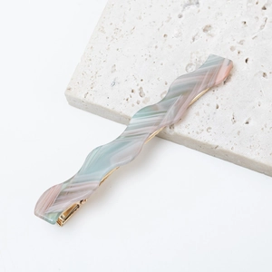 French wavy acetate marble hair clip with green and pink texture on gold duckbill base