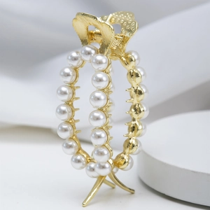 Elegant gold metal hair claw clip with white faux pearls for high ponytail hairstyles