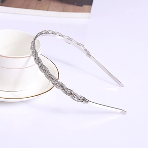 Elegant silver braided metal headband with a polished finish for a modern minimalist style