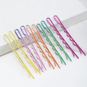 Set of 10 colorful wavy matte metal hairpins in candy colors on white background