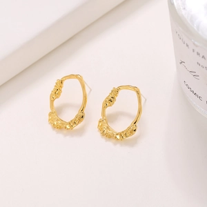Elegant gold earrings with irregular oval hollow design and molten lava hammer texture