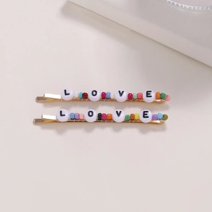 Set de dos pasadores de pelo dorados con perlas de colores y cuentas LOVE
