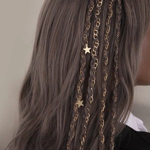 Elegant gold ponytail chain with star charms braided into long hair for a stylish hair look