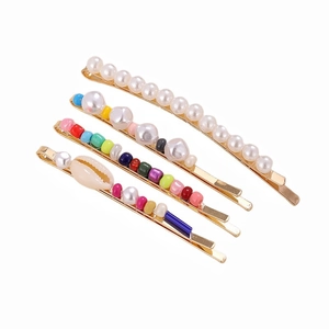 Bohemian gold hair clip set with white pearls and colorful beads on white background