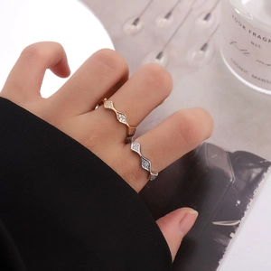 Minimalist gold and silver S-shaped wave rings with sparkling cubic zirconia accents