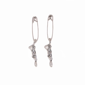Gothic style silver skeleton body pendants hanging from safety pin style earrings