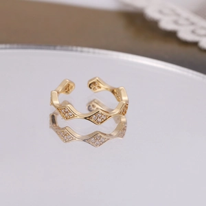 Adjustable gold wave ring with sparkling cubic zirconia in a modern geometric style