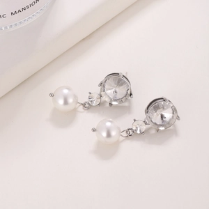 Elegant 925 silver pearl drop earrings with sparkling round zircon crystals on white