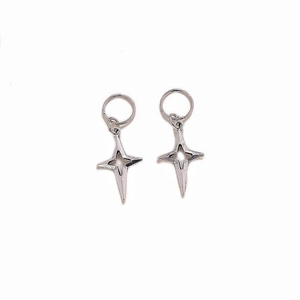Detailed close-up of silver hollow four-pointed star earrings with a matte metallic finish