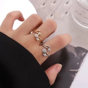 Macro detail of adjustable flower cluster rings in gold and silver with cubic zirconia