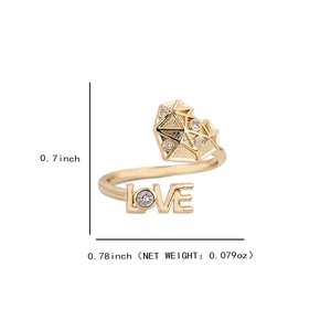 Gold open heart ring with LOVE engraving and white crystals on a white background