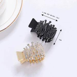 Close-up of sparkling crown-shaped claw clips in gold and black with size measurements