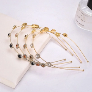 Set of four gold alloy rhinestone flower headbands with sparkling crystal accents