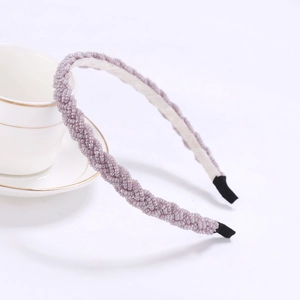 Detail of purple beaded braided headband showing intricate twisted pearls and inner fabric