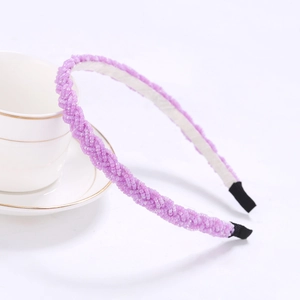 Detail of beaded purple braided headband with handcrafted texture and non-slip ends