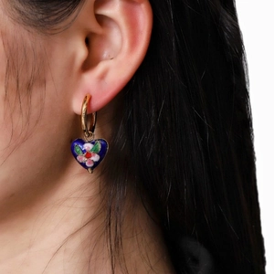 Vintage gold hoop earrings with blue heart enamel charms and colorful floral patterns
