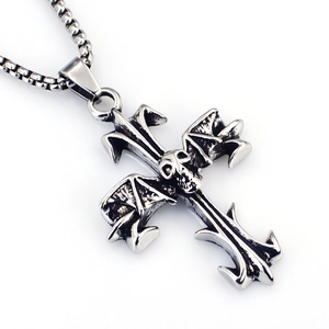 Macro view of vintage silver gothic skull cross pendant with distressed metal texture