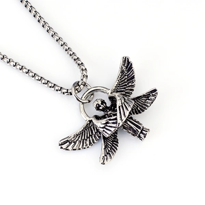 Macro shot of vintage silver archangel pendant with detailed wings on box chain