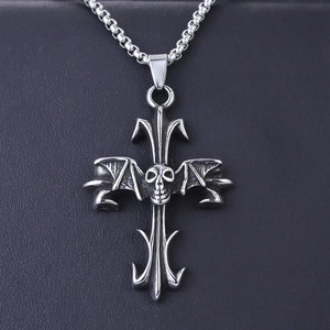 Gothic stainless steel skull and cross wing pendant necklace on black leather background