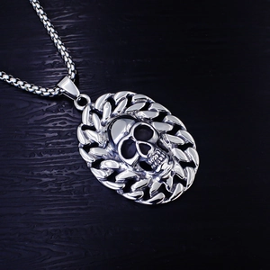 Macro shot of punk style stainless steel skull pendant with Cuban chain edge design