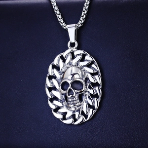 Close-up of a silver stainless steel skull pendant with a woven textured frame for men
