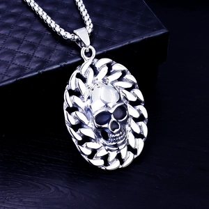 Detail shot of a punk skull pendant in silver stainless steel on a black jewelry box