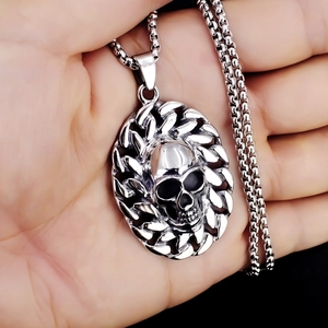 Macro shot of a stainless steel skull pendant with chain texture and box chain link