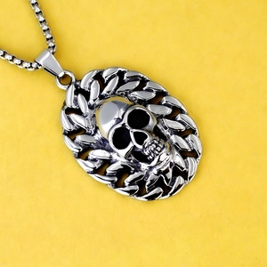 Gothic skull pendant necklace in silver stainless steel with box chain on yellow background