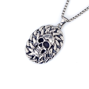 Detailed close-up of retro punk skull pendant in aged titanium steel on a box chain