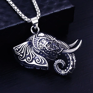 Macro detail of elephant pendant with intricate spiral engravings and silver box chain