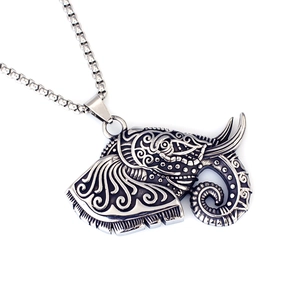 Detailed macro view of an ornate silver elephant pendant with vintage oxidized finish
