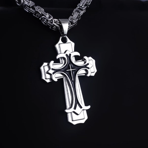Macro shot of a gothic silver cross pendant with black inlay on a heavy metal chain