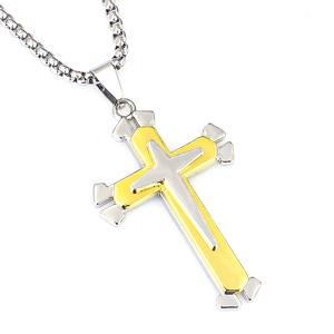 Close-up of gold and silver layered cross pendant with stainless steel chain necklace