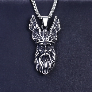 Macro shot of Viking warrior head pendant in vintage silver steel with relief details