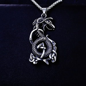 Detailed close-up of retro silver stainless steel dragon pendant with Celtic knot pattern