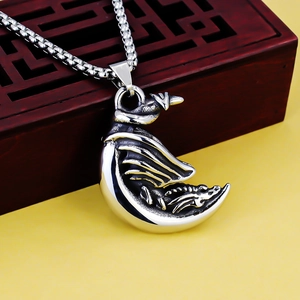Detailed view of silver dragon on crescent moon pendant with sturdy box chain necklace