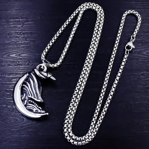 Retro stainless steel men's dragon moon pendant necklace on a black wood background