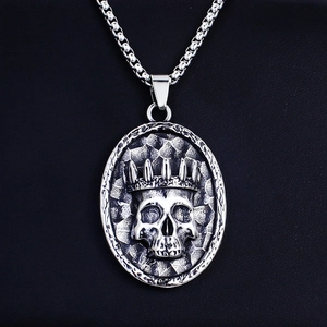 Vintage stainless steel skull necklace with crown pendant on black leather background