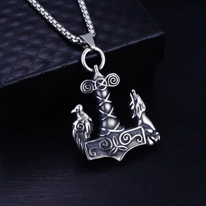 Detail view of Viking Mjolnir pendant with wolf and raven carvings in retro silver