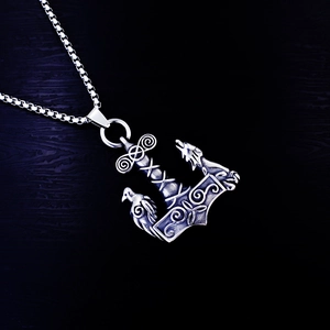 Nordic Mjölnir pendant necklace with viking crow and wolf carvings in antique silver